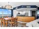Charming dining area with a chandelier, with a bright, white modern kitchen at 241 Riverside Dr # 1909, Daytona Beach, FL 32117