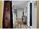 Inviting hallway with stylish wood flooring, decorative shelving, and curated art displays at 241 Riverside Dr # 1909, Daytona Beach, FL 32117