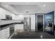 Bright kitchen with modern appliances, sleek white cabinetry, and dark countertops at 241 Riverside Dr # 1909, Daytona Beach, FL 32117