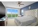 Spacious bedroom featuring a large bed, ceiling fan, and balcony with city views at 241 Riverside Dr # 1909, Daytona Beach, FL 32117