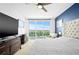 Cozy bedroom with a king bed, ceiling fan, balcony, and city views at 241 Riverside Dr # 1909, Daytona Beach, FL 32117