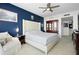Comfortable main bedroom with a tufted headboard, adjacent chair, and dark wood accents at 241 Riverside Dr # 1909, Daytona Beach, FL 32117