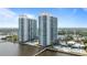 Aerial view of the modern high rise condo featuring a waterfront location and community pool at 241 Riverside Dr # 304, Daytona Beach, FL 32117