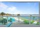 Enjoy a beautiful pool and waterfront view from the condo's balcony with glass railings and patio furniture at 241 Riverside Dr # 304, Daytona Beach, FL 32117