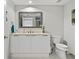 Bright bathroom featuring a single vanity, a mirror, and a conveniently placed toilet at 241 Riverside Dr # 304, Daytona Beach, FL 32117