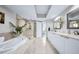 Well-lit bathroom with a tub, glass shower, and double sink vanity offers serene luxury at 241 Riverside Dr # 304, Daytona Beach, FL 32117