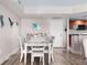 Elegant dining area with wood floors, ocean-themed decorations, and a view into the kitchen at 241 Riverside Dr # 304, Daytona Beach, FL 32117