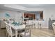 Spacious dining room with a view of the kitchen featuring wood floors and a modern design at 241 Riverside Dr # 304, Daytona Beach, FL 32117