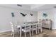 Well-lit dining room with a nautical theme, wood floors, and seating for eight at 241 Riverside Dr # 304, Daytona Beach, FL 32117