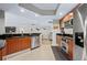 Open kitchen with wood cabinets, stainless appliances, and black countertops in a modern home at 241 Riverside Dr # 304, Daytona Beach, FL 32117