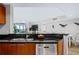 Bright kitchen with stainless dishwasher, granite countertops, with an open view of the living area and balcony at 241 Riverside Dr # 304, Daytona Beach, FL 32117