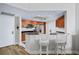 Well-lit kitchen featuring wooden cabinetry, stainless steel appliances, and a breakfast bar with seating at 241 Riverside Dr # 304, Daytona Beach, FL 32117