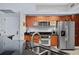 Modern kitchen with stainless steel appliances, dark countertops, wood cabinets and a stylish faucet at 241 Riverside Dr # 304, Daytona Beach, FL 32117