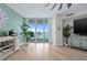 Bright living room with light wood floors, ocean decor, and expansive windows with waterfront views at 241 Riverside Dr # 304, Daytona Beach, FL 32117