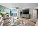 Open living room with light wood floors, comfortable seating, and scenic waterfront views at 241 Riverside Dr # 304, Daytona Beach, FL 32117