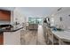 Expansive view of the living, dining, and kitchen areas, with light wood floors and waterfront views at 241 Riverside Dr # 304, Daytona Beach, FL 32117