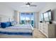 Comfortable main bedroom featuring a king bed, dresser, and sliding glass doors leading to a balcony at 241 Riverside Dr # 304, Daytona Beach, FL 32117