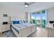 Bright main bedroom featuring a king bed, water views, and balcony access at 241 Riverside Dr # 304, Daytona Beach, FL 32117