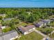 Aerial view of the home and the neighborhood surrounded by lush trees, showcasing the property's serene setting at 243 S Hull Ave, Deland, FL 32720