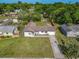 Aerial view of the home with a well-manicured lawn and mature trees, highlighting its curb appeal at 243 S Hull Ave, Deland, FL 32720