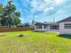 A spacious backyard with a well-kept lawn and a wooden fence, offering privacy and space for outdoor activities at 243 S Hull Ave, Deland, FL 32720