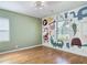 Bright bedroom with hardwood floors, fun animal mural, and a window at 243 S Hull Ave, Deland, FL 32720