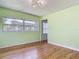 Light-filled bedroom with large window and hardwood floors at 243 S Hull Ave, Deland, FL 32720