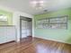 Bright bedroom with wood floors and an organized closet at 243 S Hull Ave, Deland, FL 32720