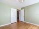 Bedroom with hardwood floors, green-painted walls and multiple doorways at 243 S Hull Ave, Deland, FL 32720