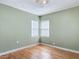 Bedroom with hardwood floors and a corner window with white blinds at 243 S Hull Ave, Deland, FL 32720