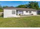 Cozy single-story home with an attached garage and well-kept lawn at 243 S Hull Ave, Deland, FL 32720