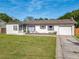 Charming single-story home with well-maintained front yard and attached garage at 243 S Hull Ave, Deland, FL 32720