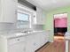 Bright kitchen with white cabinets and double sink at 243 S Hull Ave, Deland, FL 32720