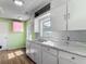 Cozy kitchen featuring white cabinets and countertops with a double basin stainless steel sink at 243 S Hull Ave, Deland, FL 32720