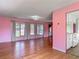 Bright living room with hardwood floors, and large windows offering plentiful natural light at 243 S Hull Ave, Deland, FL 32720