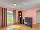 Cozy living room with wood floors and window with natural light at 243 S Hull Ave, Deland, FL 32720