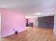 Open living room with hardwood floors and stone accent wall for modern design at 243 S Hull Ave, Deland, FL 32720