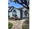 Charming single-story home with white siding, blue trim, and beautifully landscaped front yard at 2596 Lancaster Ct, Apopka, FL 32703
