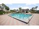 Community pool with ample lounge chairs and a covered pavilion, perfect for relaxation and recreation at 2596 Lancaster Ct, Apopka, FL 32703