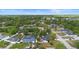 Aerial view of neighborhood showcasing mature trees and well-maintained properties at 265 S Fairbairn Dr, Deltona, FL 32725