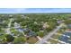 Aerial view of neighborhood showcasing mature trees and well-maintained properties at 265 S Fairbairn Dr, Deltona, FL 32725