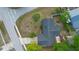 Aerial view of home with well-manicured lawn, driveway, and nearby street at 265 S Fairbairn Dr, Deltona, FL 32725