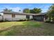 Spacious backyard with lush greenery, screened-in patio, and ample space at 265 S Fairbairn Dr, Deltona, FL 32725