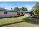 A backyard features a well-maintained lawn, perfect for outdoor activities and relaxation at 265 S Fairbairn Dr, Deltona, FL 32725