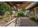 Backyard patio area with wooden pergola and tropical landscaping at 265 S Fairbairn Dr, Deltona, FL 32725