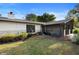 Exterior view of home with screened-in porch and brick accents at 265 S Fairbairn Dr, Deltona, FL 32725