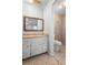 Bathroom featuring a updated sink, framed mirror, and tiled shower at 265 S Fairbairn Dr, Deltona, FL 32725