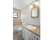 Bathroom with tub, tile flooring, updated sink and framed mirror at 265 S Fairbairn Dr, Deltona, FL 32725