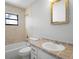 Bathroom with a tub, toilet, and vanity with light brown countertops and decorative tiling at 265 S Fairbairn Dr, Deltona, FL 32725