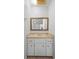 Bright bathroom featuring a vanity with white cabinets and a gold-trimmed mirror at 265 S Fairbairn Dr, Deltona, FL 32725